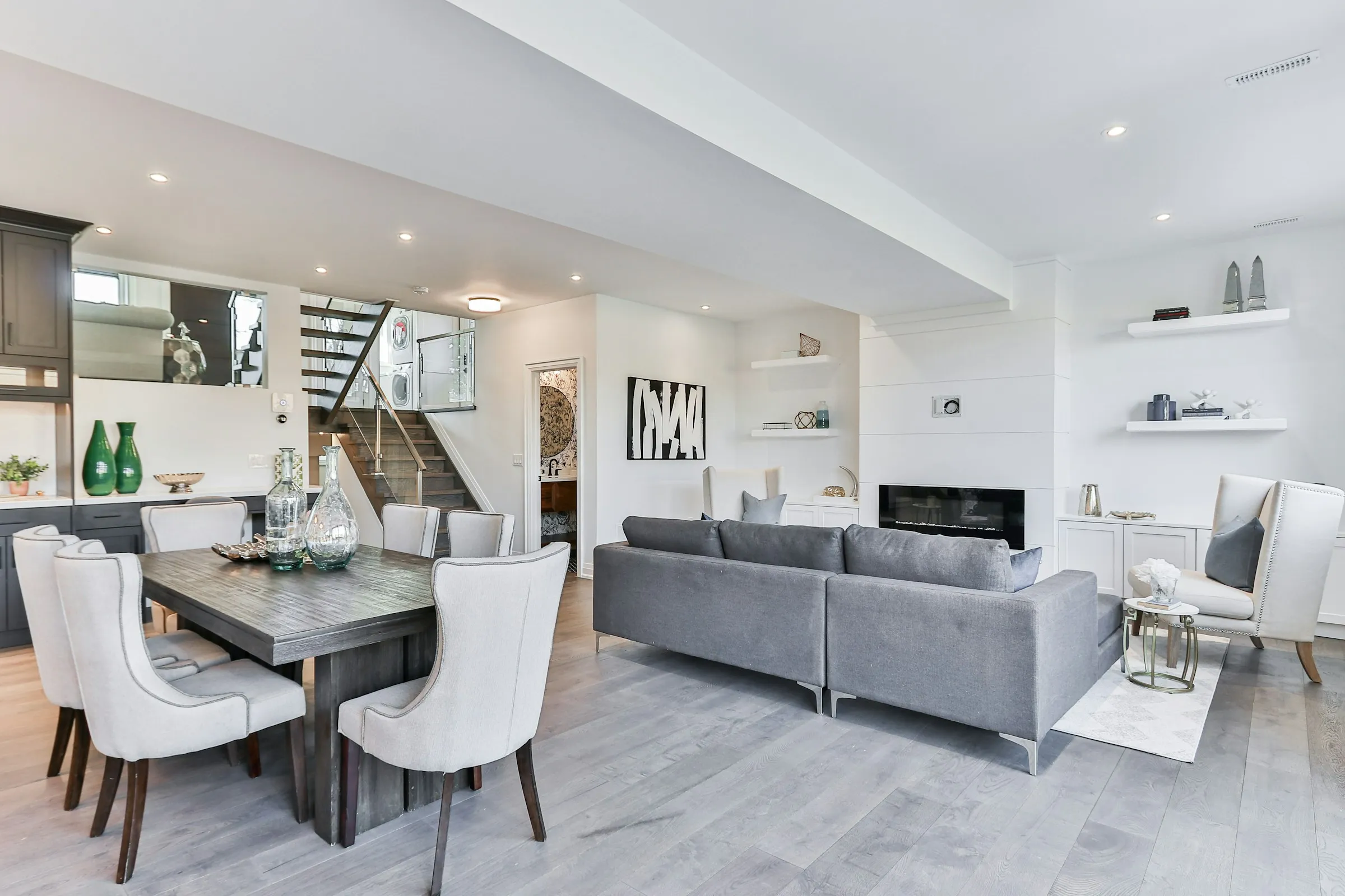 Modern home interior with open living room, dining area, and staircase