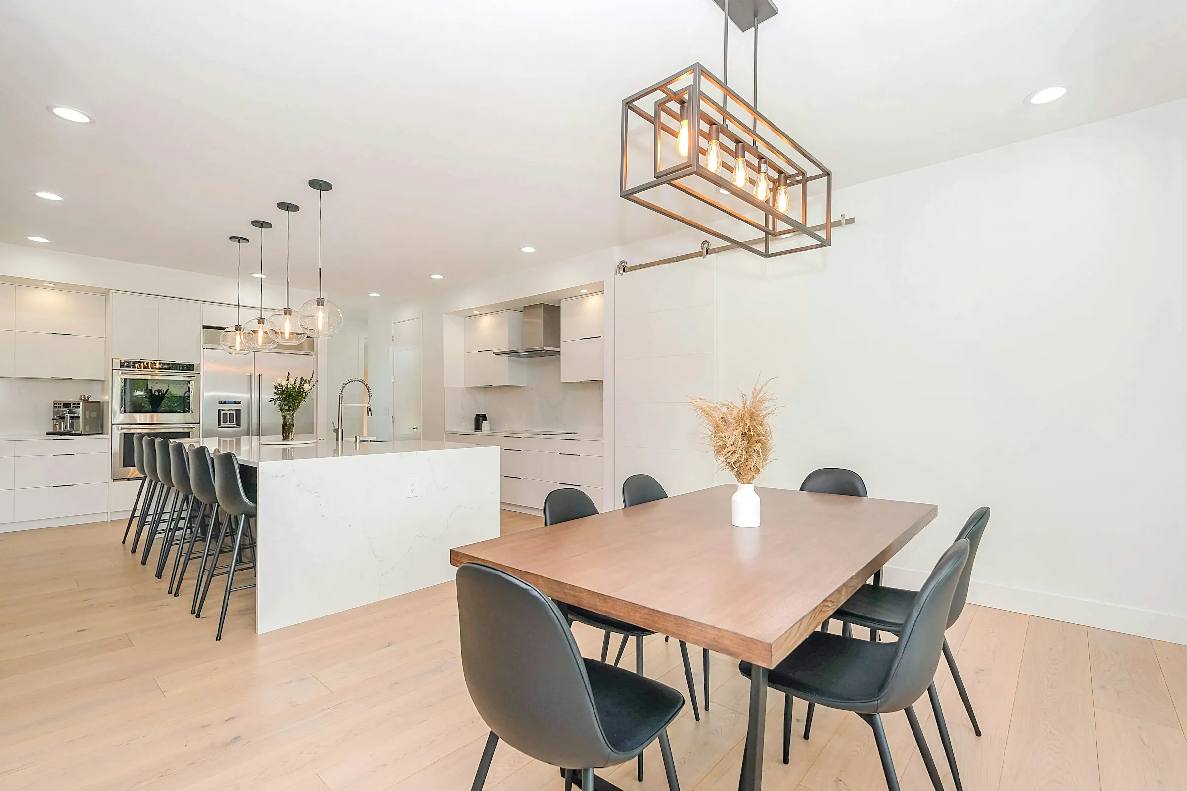Modern condo interior with open kitchen, dining area, and island seating