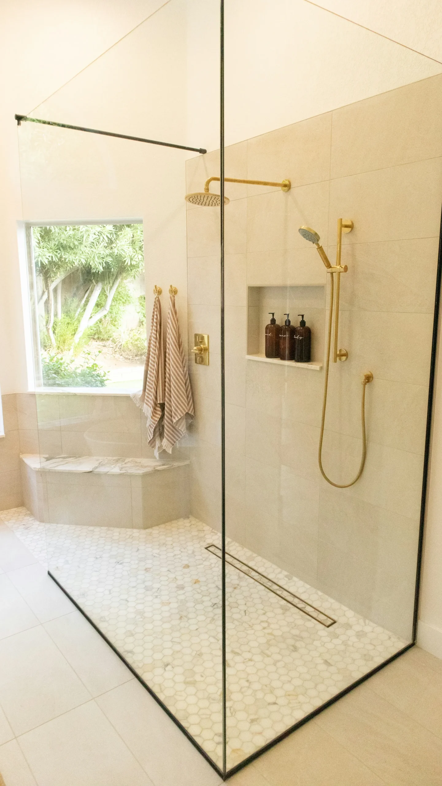 Thin-framed glass shower enclosure in a modern bathroom